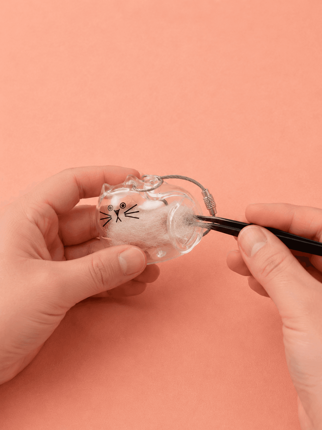Close-up of Fur Keepsake Keychain collection materials and clear pet-shaped keychain