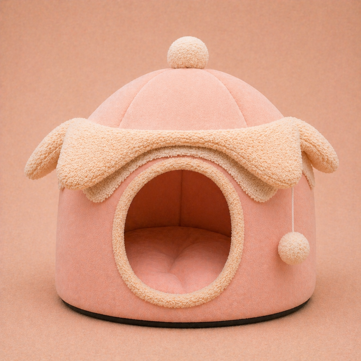 Pink felt dome cave dog bed with ear and pom-pom details